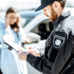 police issuing a traffic ticket to a driver in Ontario